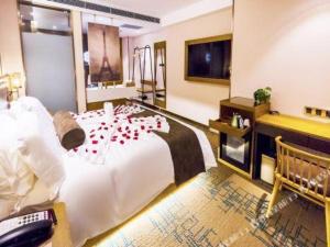 a bedroom with a large bed with red roses on it at James Joyce Coffetel Changchun People's Square in Changchun