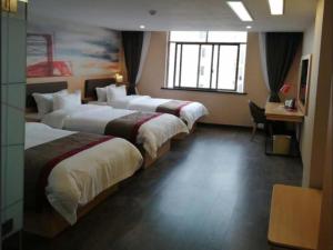 Vuode tai vuoteita majoituspaikassa Thank Inn Plus Hotel Guangxi Laibin Xiangzhou County Wenhua Square