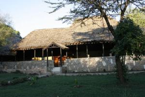 a large building with a straw roof at Ol Moran Tented Camp in Ololaimutiek