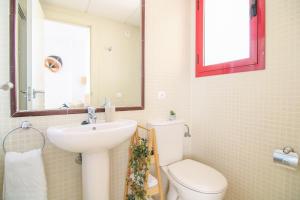 a bathroom with a toilet and a sink and a mirror at RIURAU HOME Playa Arenal - Amatista in Calpe