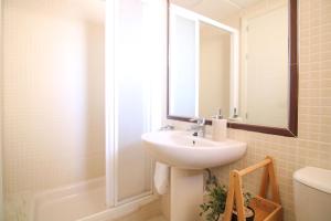 a bathroom with a sink and a mirror and a shower at RIURAU HOME Playa Arenal - Amatista in Calpe