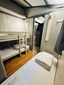 a small room with two bunk beds in it at Le Chalet de Louise 7 places in Taradeau