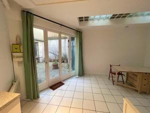 a room with a large window and a table at T2 sur cour au coeur des JO 2024 in Saint-Denis