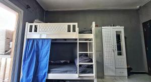 a bunk bed with two bunk beds in a room at Dubai Zeus Hostel in Dubai