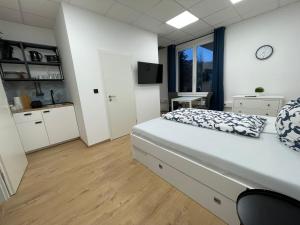 a bedroom with a bed and a large window at Smart In Göttingen - Apartments & Rooms in Göttingen