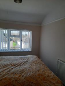 1 dormitorio con cama y ventana grande en Entire Three Bedroom House in Birmingham en Birmingham