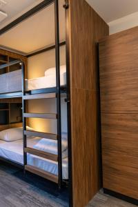 a bunk room with two bunk beds and a closet at Haka House Queenstown Lakefront in Queenstown