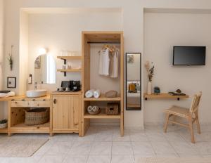 a bathroom with a sink and a mirror at Capella Town, Skiathos in Skiathos Town