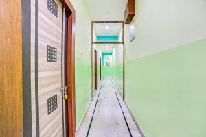 a corridor of an empty room with green walls at FabExpress Nest in Kolkata