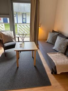 a living room with a couch and a coffee table at Sankt Helene Holiday Center in Tisvildeleje