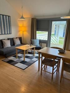 a living room with a couch and a table at Sankt Helene Holiday Center in Tisvildeleje