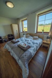 a bedroom with a bed with two plates on it at Wellness Penzion Life in Číměř