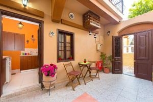 a kitchen and dining room with a table and chairs at Muses-Old Town in Rhodes Town