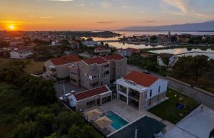 an aerial view of a house with a sunset at Luxury Villa Salt & Stone with spa area in Nin in Nin