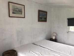 a bedroom with a bed and two pictures on the wall at Les Chalets de Babeth et Cathy 
