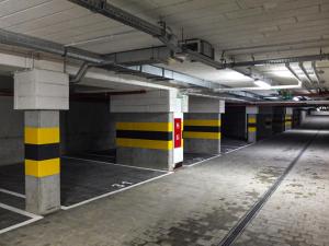 an empty parking garage with yellow and black columns at Apartament Lublin Centrum "Ice Cat" FREE PARKING in Lublin