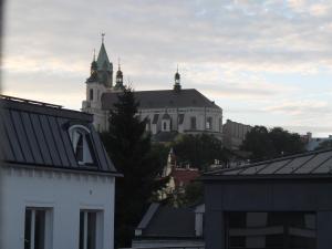 a building in the distance with roofs of buildings at Apartament Lublin Centrum "Ice Cat" FREE PARKING in Lublin +10 photos