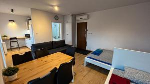 a living room with a table and a couch at Apartament Lublin Centrum "Ice Cat" FREE PARKING in Lublin