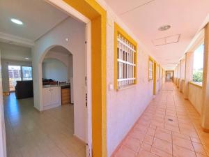 an empty hallway of a house with yellow and white walls at Mar de Cristal Resort Apartamentos - Parking in Mar de Cristal