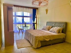 a bedroom with a bed in a room with a window at Julia Ocean View Villa in Ukunda +25 photos