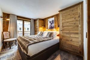 a bedroom with a large bed and a large window at Résidence Grizzly - 4 Pièces pour 6 Personnes 734 in Val-d'Isère