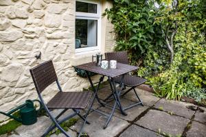 a table and two chairs sitting on a patio at Cosy Cottage Fishguard in Fishguard