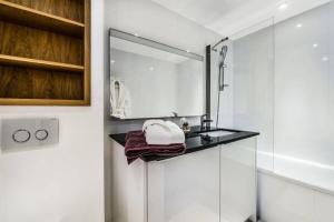 a white bathroom with a sink and a mirror at Residence Saint-charles - 3 Pièces pour 5 Personnes 844 in Val-d'Isère