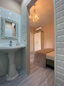 a bathroom with a sink and a bed at Appartamento in pieno centro a Trento in Trento