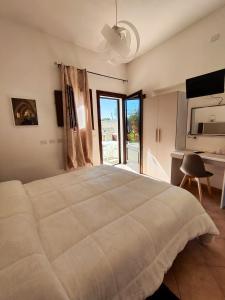 a bedroom with a large bed and a desk at Casolare Nelle Saline in Torre Nubia +80 photos