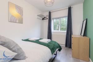 レミントン・スパにある3BR Home with Driveway Leamington Spa Town Centreのベッドと窓のある寝室