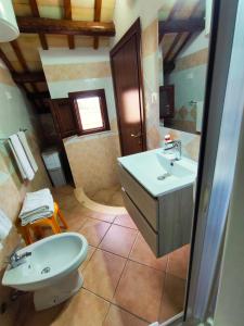 a bathroom with a sink and a toilet at Casolare Nelle Saline in Torre Nubia