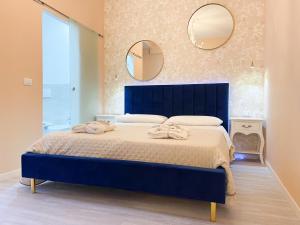 a bedroom with a blue bed with two towels on it at Appartamento in pieno centro a Trento in Trento