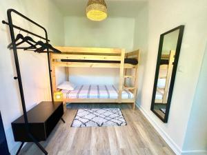 a room with a bunk bed with a mirror at Pine & Apple Sintra Beach House in Colares