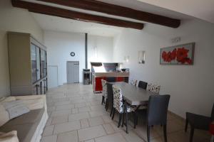 ein Wohnzimmer mit Tisch und Stühlen und einer Couch in der Unterkunft La maison d'Anthonie, Roussillon in Roussillon