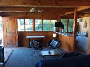 a living room with a couch and a table at Refugio ALTO ANCOA in Linares