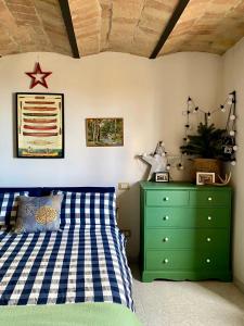 Un dormitorio con una cama verde y una cómoda verde en Terracielo Ramona B&B Homestay Penne en Penne