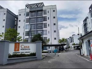 a tall white building with a sign in front of it at D'Mulya Homestay in Chemor