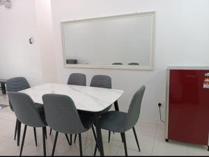 a meeting room with a white table and chairs at D'Mulya Homestay in Chemor