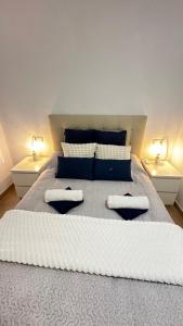 a bedroom with a large bed with two lamps at Apartament MARA in Torrevieja