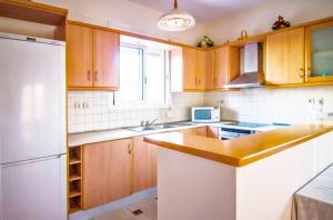 A kitchen or kitchenette at Villa Fotini with ocean view