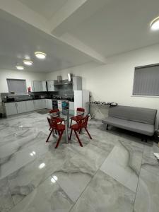 a kitchen with a table and chairs and a couch at Vic Vic property in Oldham