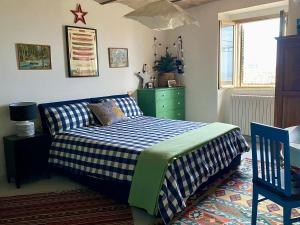a bedroom with a bed and a green dresser at Terracielo Ramona B&B Homestay Penne in Penne