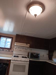 a kitchen with a stove and a light on the ceiling at Westfield's best choice in Westfield