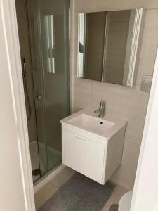a bathroom with a white sink and a shower at Stunning 3-Bed 3-Bath Apartment in Southampton in Southampton