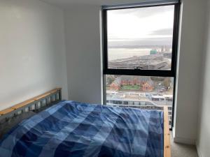 a bedroom with a bed and a large window at Stunning 3-Bed 3-Bath Apartment in Southampton in Southampton