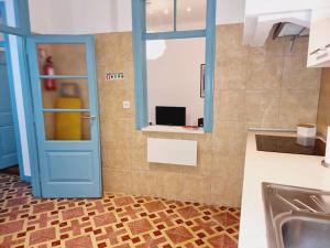 a kitchen with a blue door and a sink at Casa Azul by Ericeira Property in Ericeira +28 photos