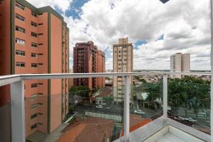 a balcony with a view of a city with tall buildings at Lym Flat Hotel in Uberlândia