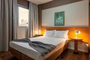 Postel nebo postele na pokoji v ubytování Lym Flat Hotel
