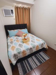 a bedroom with a bed with a suitcase on it at 1 bedroom in Pioneer Woodlands Condo near Mrt Boni Mandaluyong in Manila