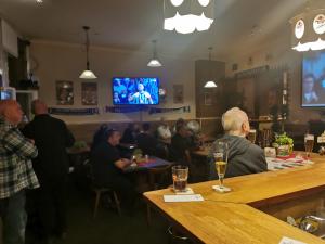 a group of people sitting at a bar in a restaurant at FEWO3-1 Zim-2 Einz Bett-2 Pers-Küche-Dusche WC in Berlin